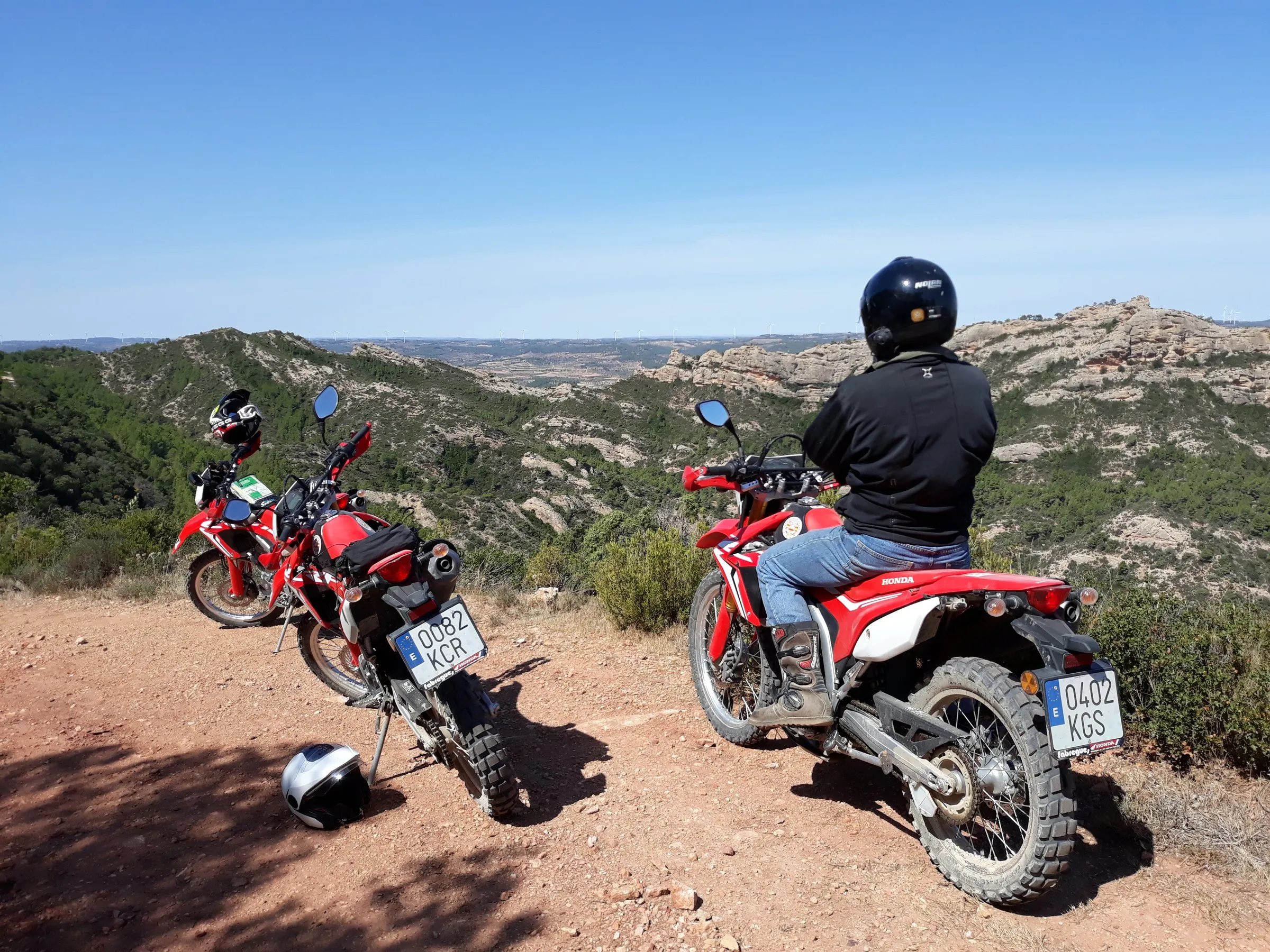 Honda CRF250L trail bikes lined up ready to ride outside the property in Catalonia