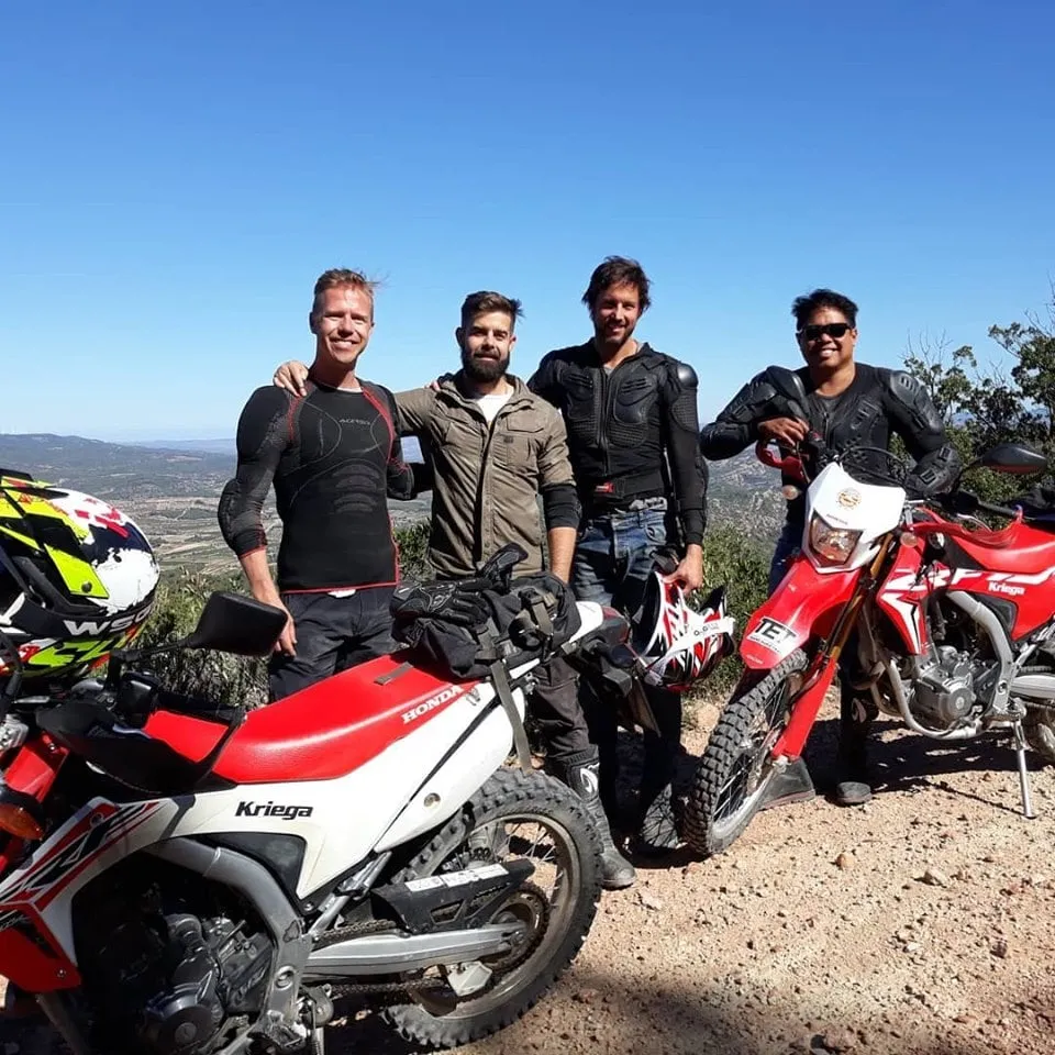 Group of riders on trail bikes pausing on a mountain track in Southern Catalonia