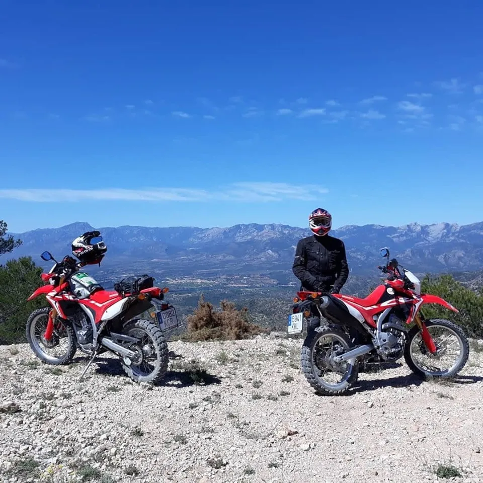 Riders on trail bikes stopped on a mountain track